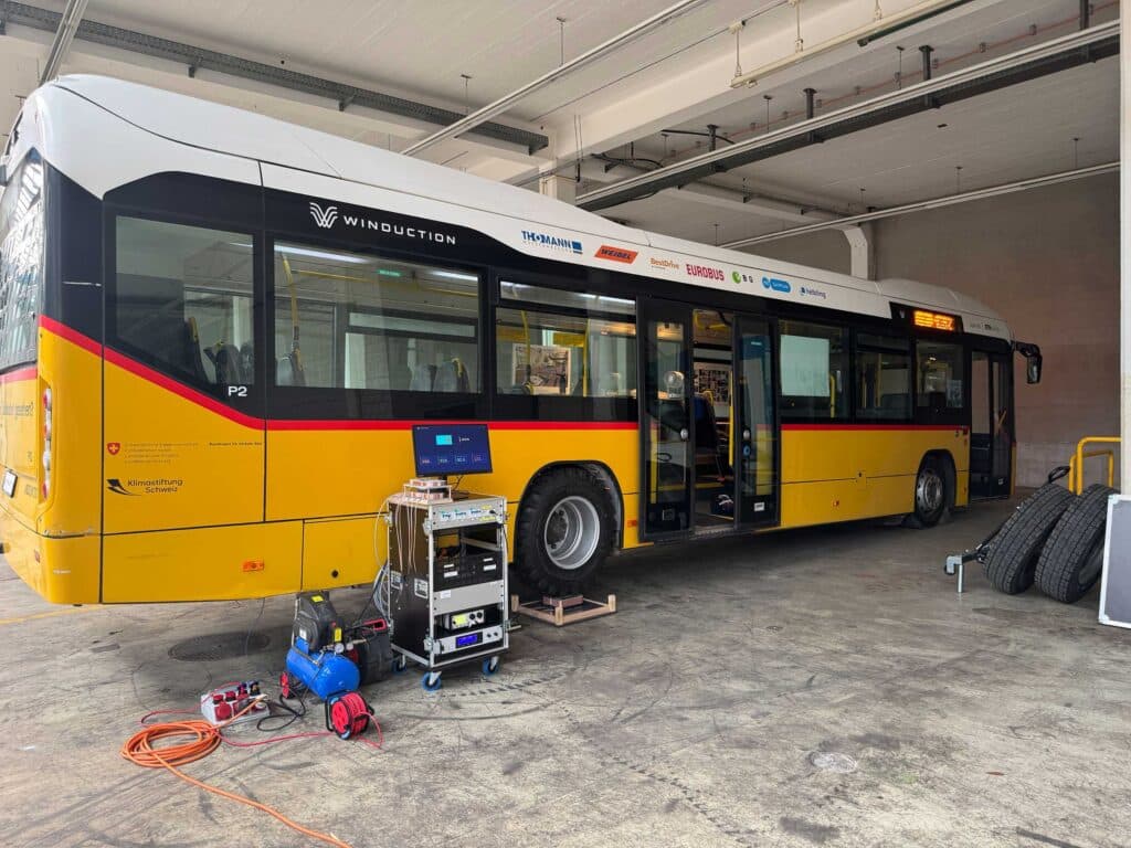 Rear wheel of Winduction's prototype bus on a wireless charging plate